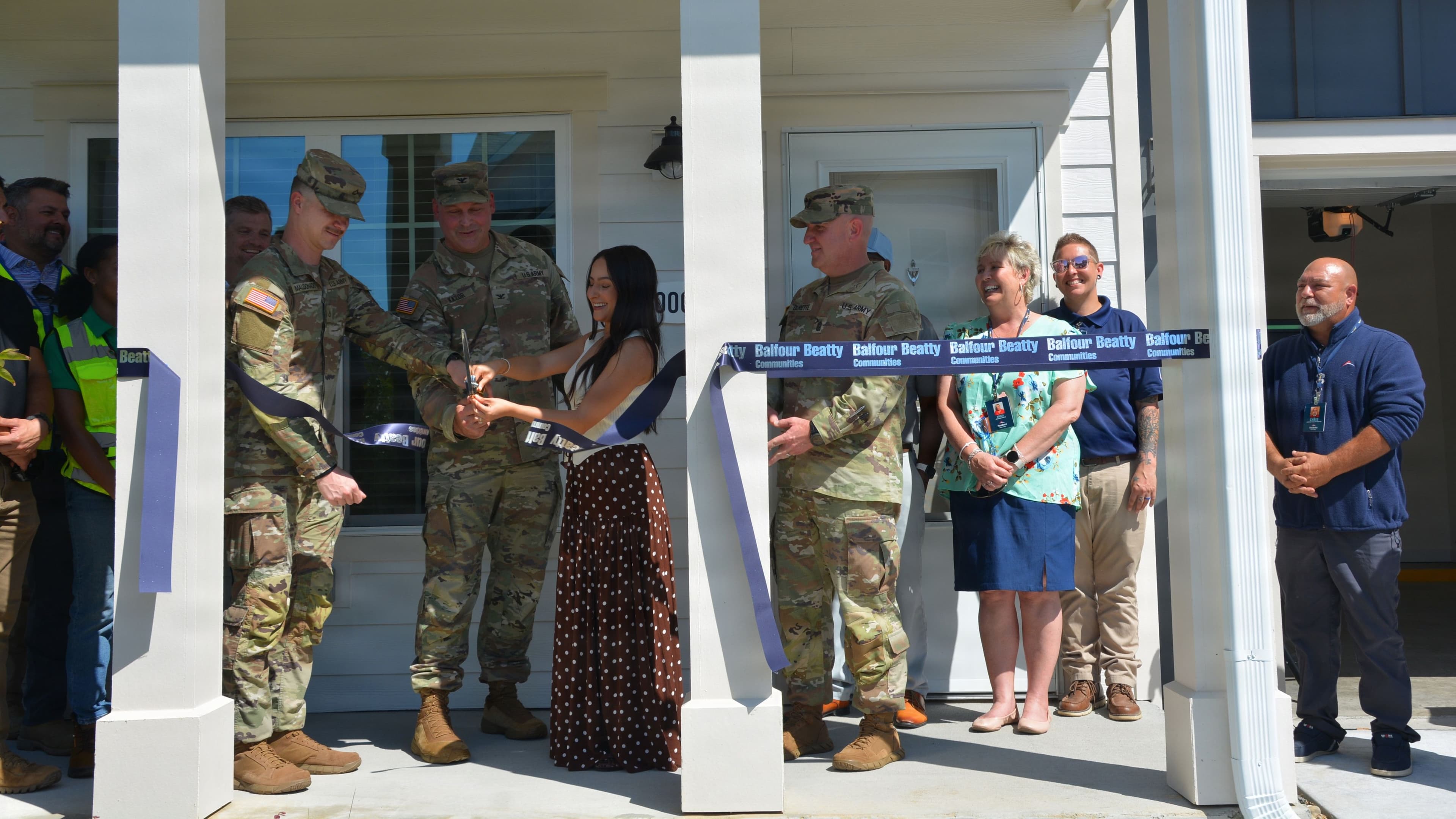 Ribbon-cutting of new housing by soldiers and families.