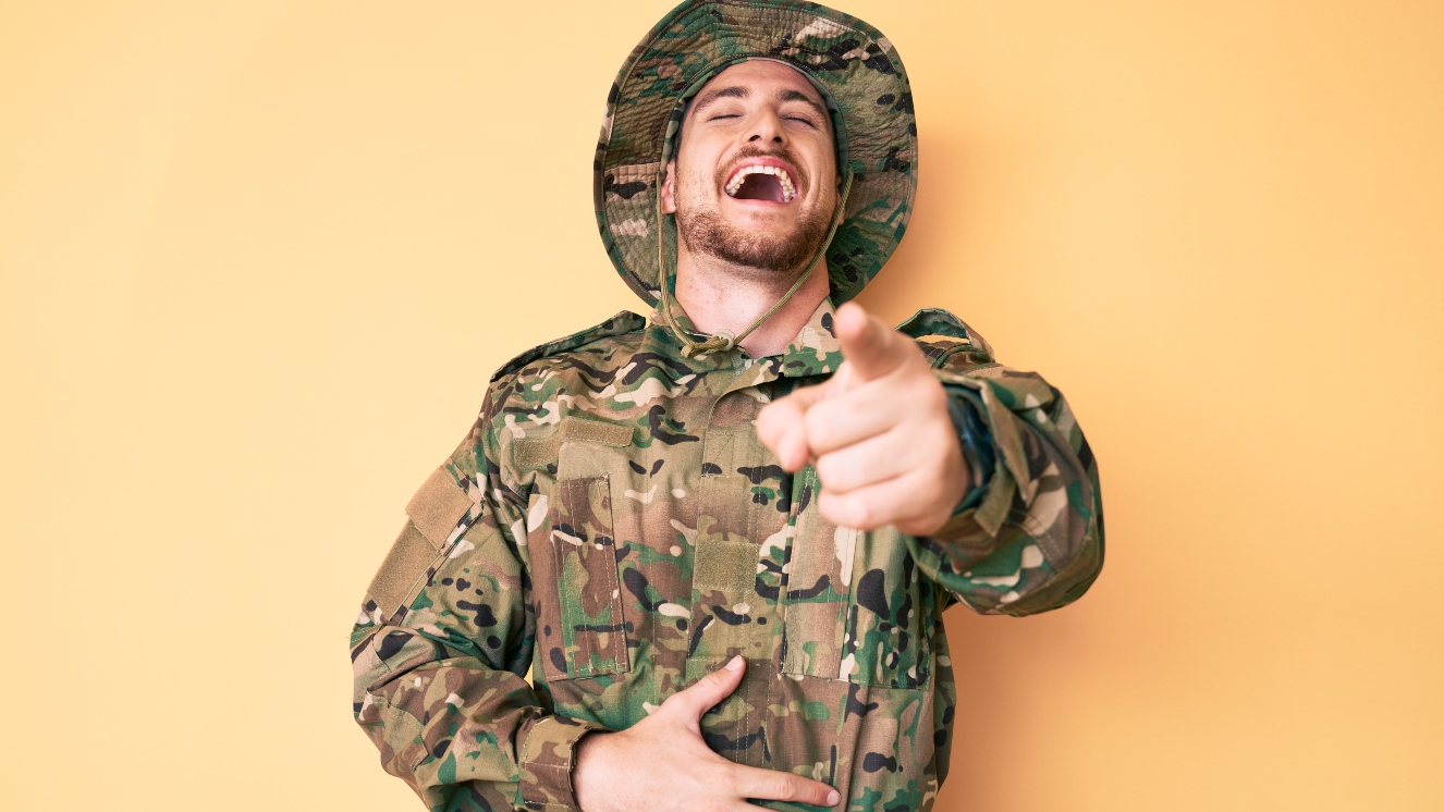man laughing at military jokes