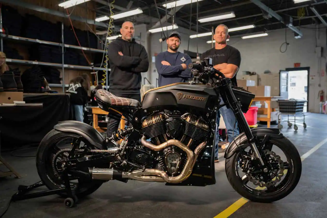 Origin team Jocko Willink, Pete Roberts, and Tony Audette standing by their motorcycle