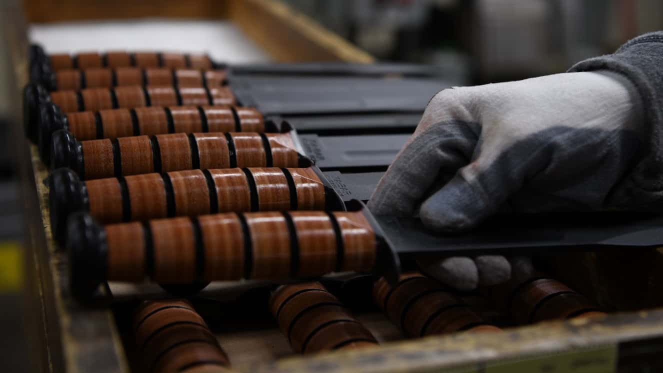 A KA-BAR employee places a USMC Fighting/Utility KA-BAR knife on a tray, awaiting for the next process at a factory in Olean, New York, Nov. 19, 2019. KA-BAR has been issuing the USMC Fighting/Utility KA-BAR knives to the Marine Corps since Dec. 9, 1942. (U.S. Marine Corps photo by Lance Cpl. Mellizza P. Bonjoc)