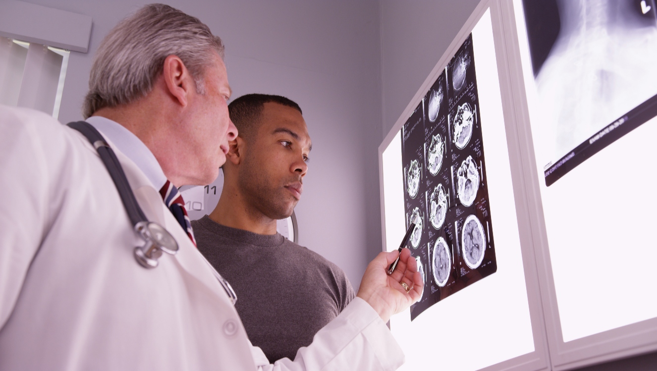 doctor and patient review brain injury on x-rays