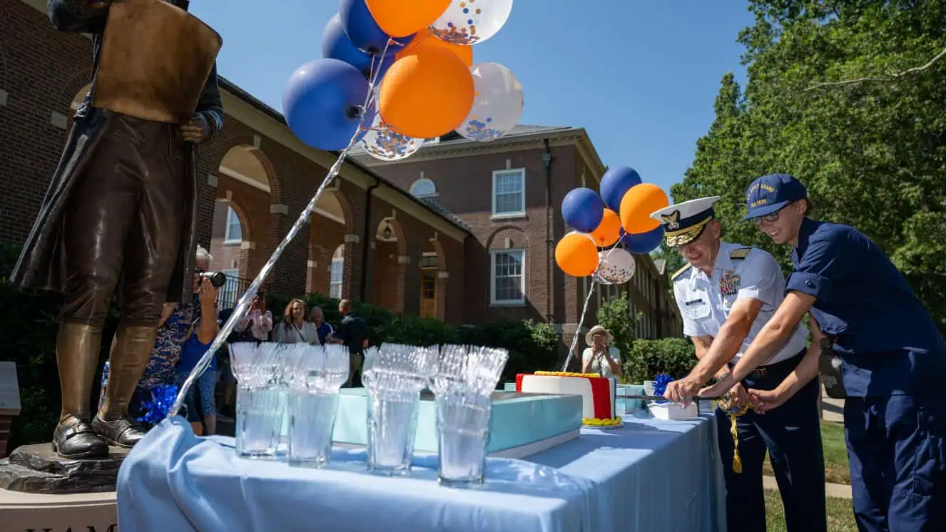 Rear Admiral William G. Kelly cuts birthday cake at a Coast Guard birthday celebration at the Coast Guard Academy in 2022.