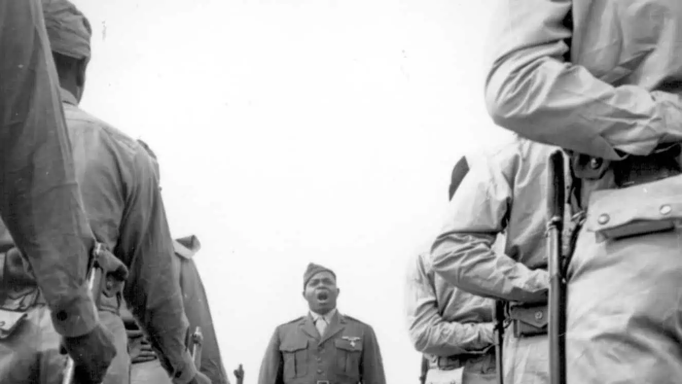 A platoon of Montford Point Marines recruits listen to their drill instructor, Sgt. Gilbert Hubert Johnson, whose job is to turn them into finished Marines at Montford Point, Camp Lejeune, N.C., April 1943.