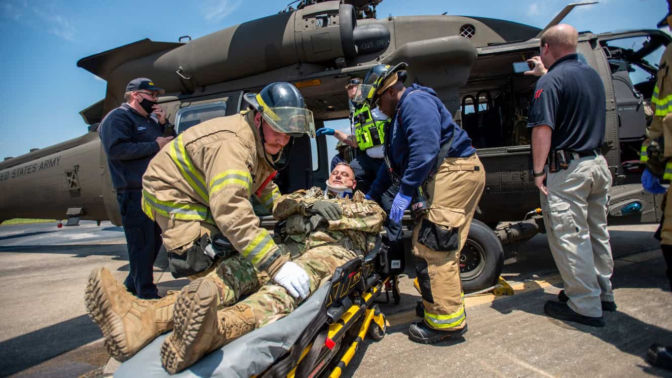 Firefighters from the Tulsa, Oklahoma Fire Department and EMSA personnel extract a simulated casualty played by an Oklahoma Army National Guard Citizen-Soldier from a mock helicopter crash during pre-accident training at the Oklahoma National Guard's Army Aviation Support Facility 2 in Tulsa, Oklahoma, May 12, 2021. Pre-accident training prepares Army aviation units to respond to accidents ranging from slip and falls to mass casualty events, and reduces military training deaths.