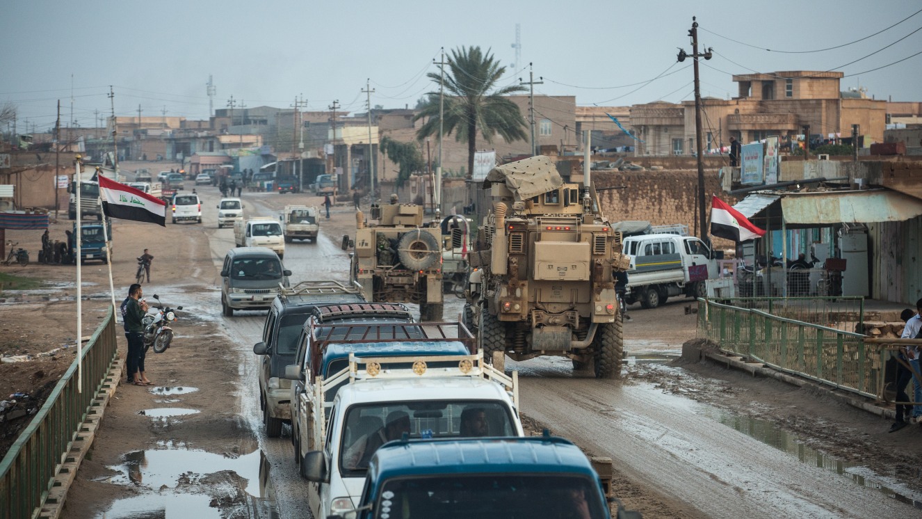 A Combined Joint Task Force (CJTF-OIR) convoy passes through downtown Al Qaim, Iraq, Dec. 5, 2018. This area was once occupied by ISIS who have been pushed into the Middle Euphrates River Valley in Syria where the Syrian Democratic Forces are fighting to clear the last remaining pockets of ISIS.