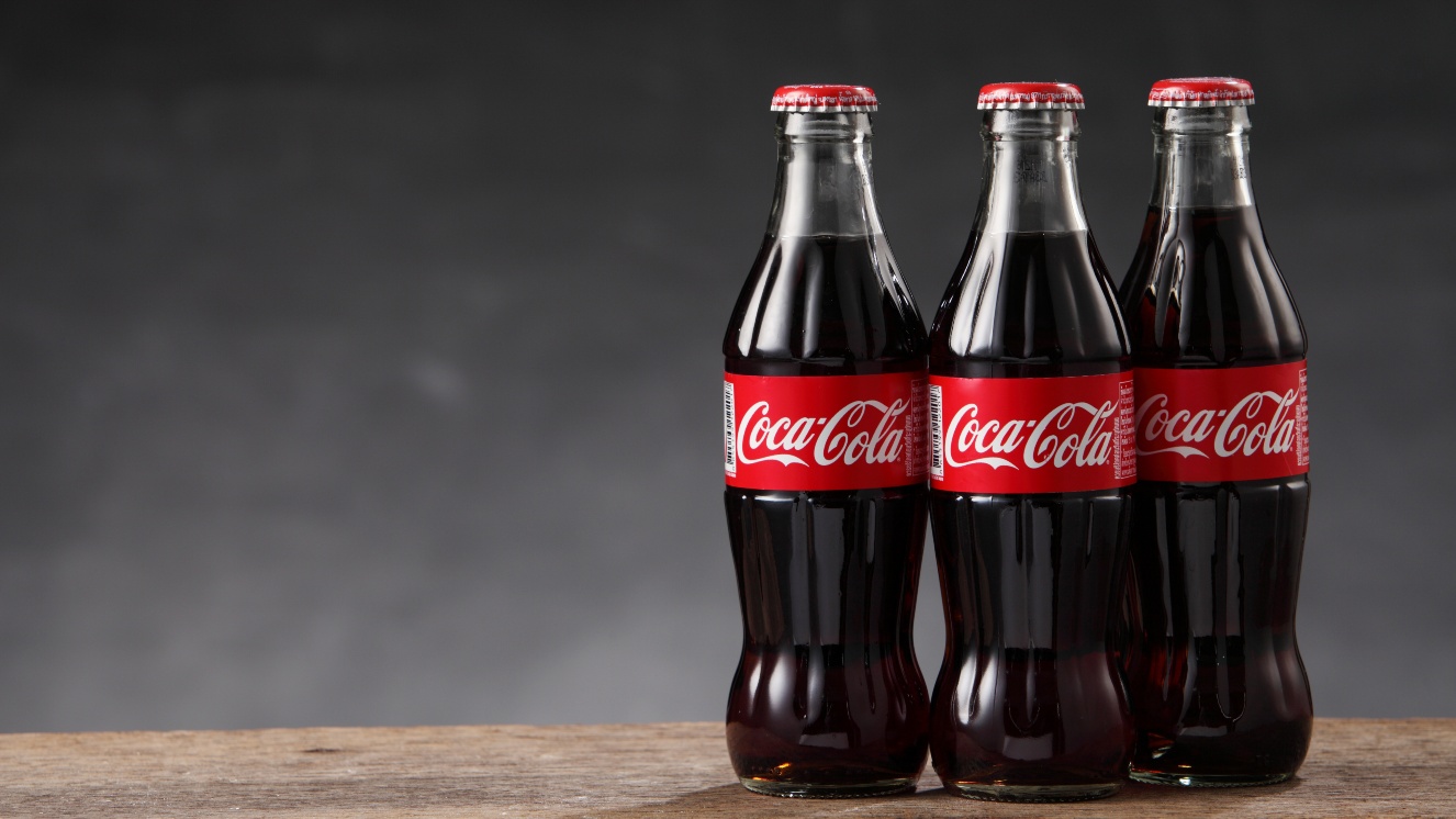 Three bottles of Coca-Cola, invented during the Civil War by a soldier from the Confederacy. Now one of the world's largest beverage companies.