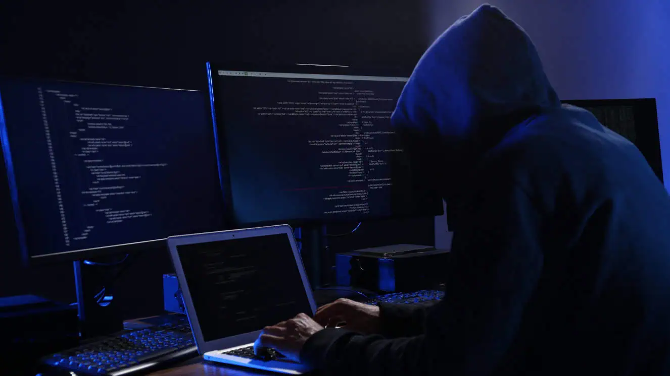 A hooded person runs a cyber operation, like Donbass Devushka who was recently identified for spreading misinformation online.