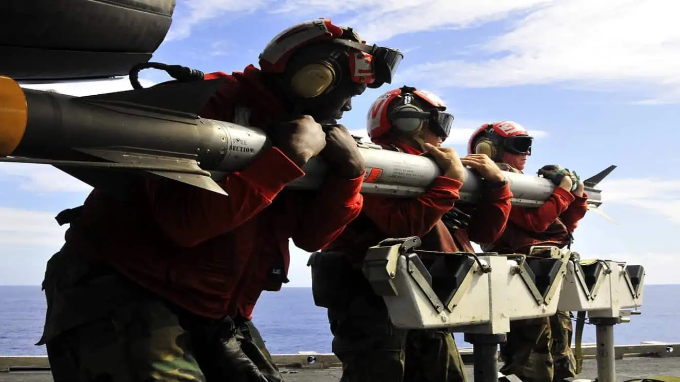 Sailors move a missile to an F/A-18C Hornet aboard the aircraft carrier USS George Washington (CVN 73).