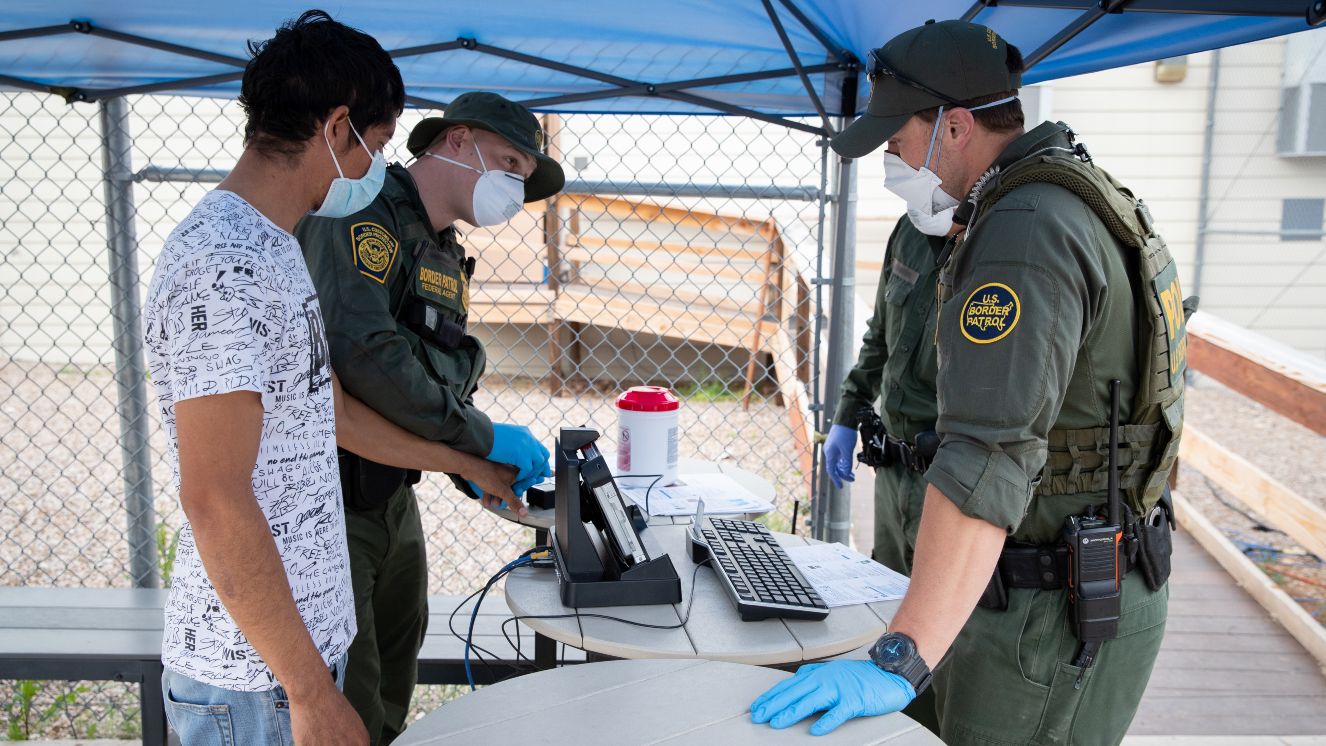 U.S. Customs and Border Protection operations following the implementation of Title 42 USC 265 at the northern and southern land borders. A U.S. Border Patrol agent uses personal protective equipment as he takes fingerprints of an individual encountered near Sasabe, Ariz. on March 22, 2020.