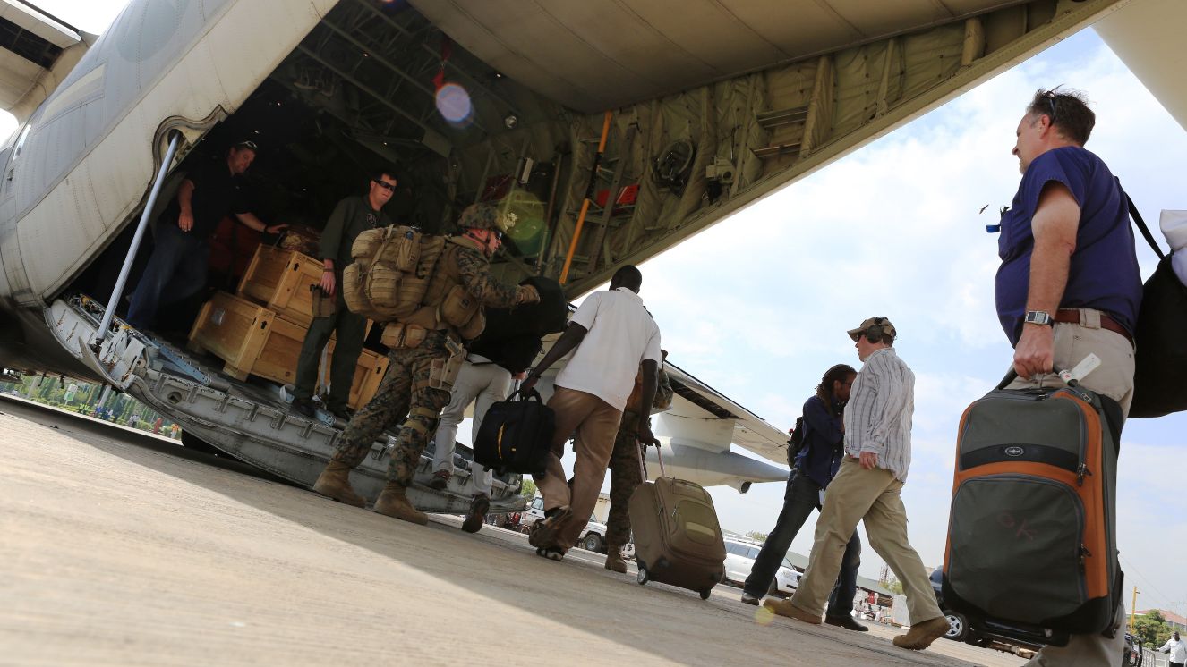 An evacuation from the US embassy, Sudan. Marines and sailors with Special-Purpose Marine Air-Ground Task Force Crisis Response help U.S. citizens into a Marine Corps KC-130J Hercules airplane in Juba, South Sudan.