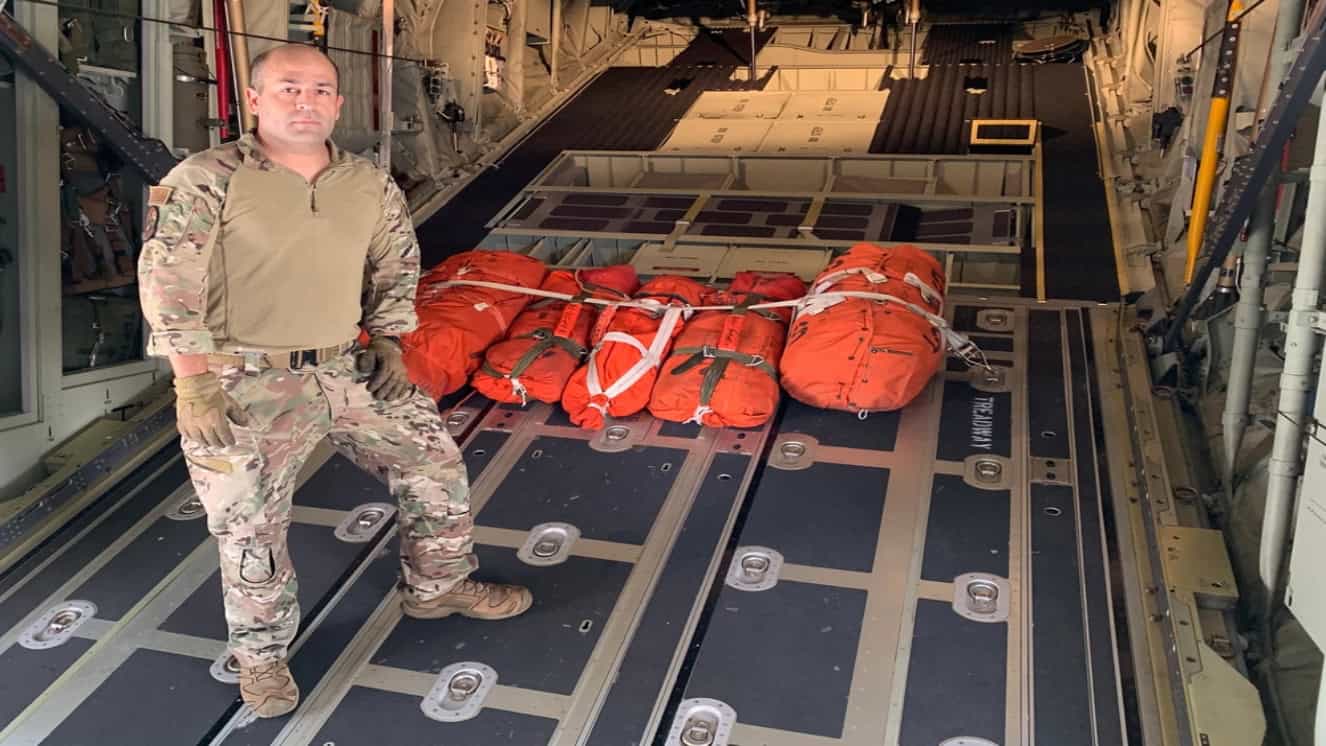 A loadmaster assigned to the 106th Rescue Wing prepares to load a C-130J Combat King II heading out to search for a submersible lost while diving on the wreck of the Titanic.