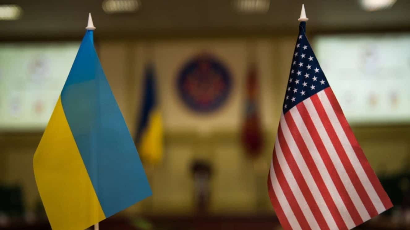 The flags of the United States and Ukraine are seen inside a conference room at Rapid Trident. US military aid to Ukraine is an ongoing conversation for both nations.