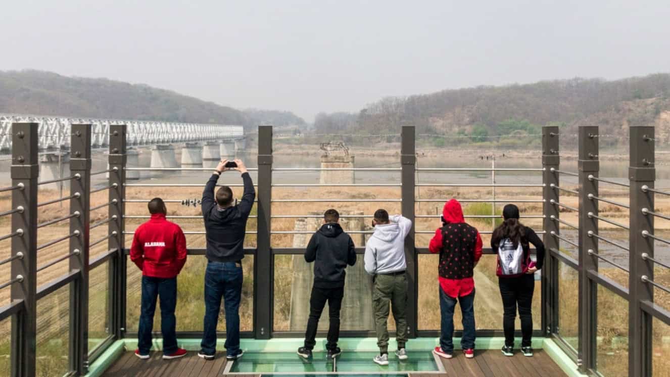 U.S. Marines with Marine Attack Squadron (VMA) 311 and Marine Aviation Logistics Squadron (MALS) 12, look over what was once a bridge that connected North Korea and South Korea during a tour to the Korean Demilitarized Zone. by the 38th parallel.