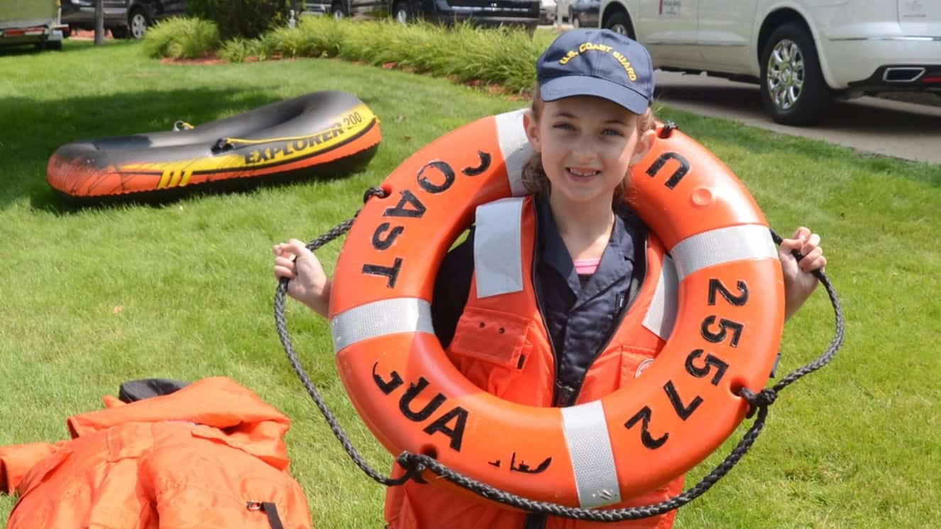 Laura Hudec, a 7-year-old from Hampshire, Ill., participates in a kids life saving obstacle course held outside of the Coast Guard Sector Grand Haven Field Office during the Grand Haven Coast Guard Festival in Grand Haven, Michigan.