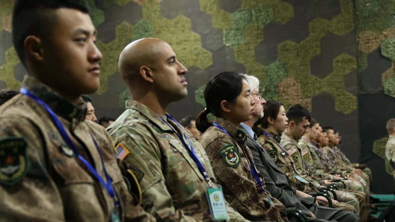 Soldiers from the United States and People’s Liberation Army China sit side-by-side during the opening ceremony of the U.S. China Disaster Management Exchange held Nov. 13-18 2018. Project 141 goes on in the background of collaborations between the two nations.