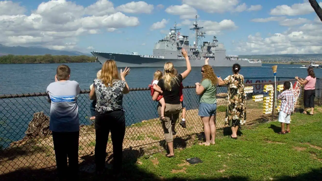 Family and friends wave farewell to Sailors aboard guided-missile cruiser USS Port Royal (CG 73) as it departs Naval Station Pearl Harbor for deployment. Port Royal and guided-missile destroyer USS Hopper (DDG 70) deployed with the San Diego element of Tarawa Expeditionary Strike Group for a deployment to the 5th and 7th Fleet areas of responsibility. The Fat Leonard scandal centers around illicit activity with the 7th Fleet.