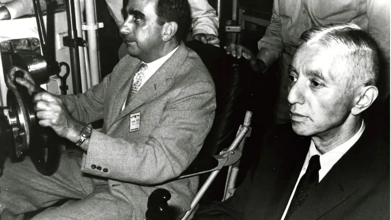 Admiral Rickover sitting in the cabin of a submarine.