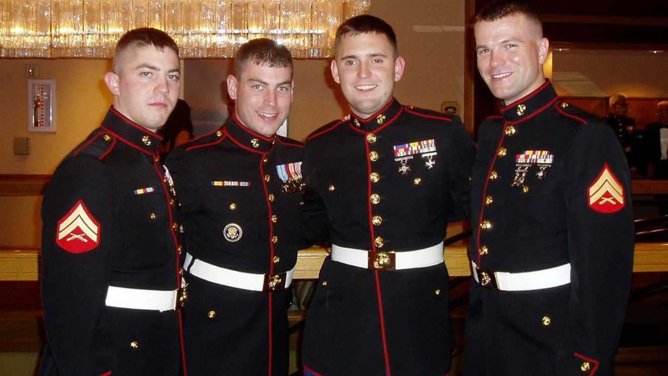 Marine jarheads standing together in a room.