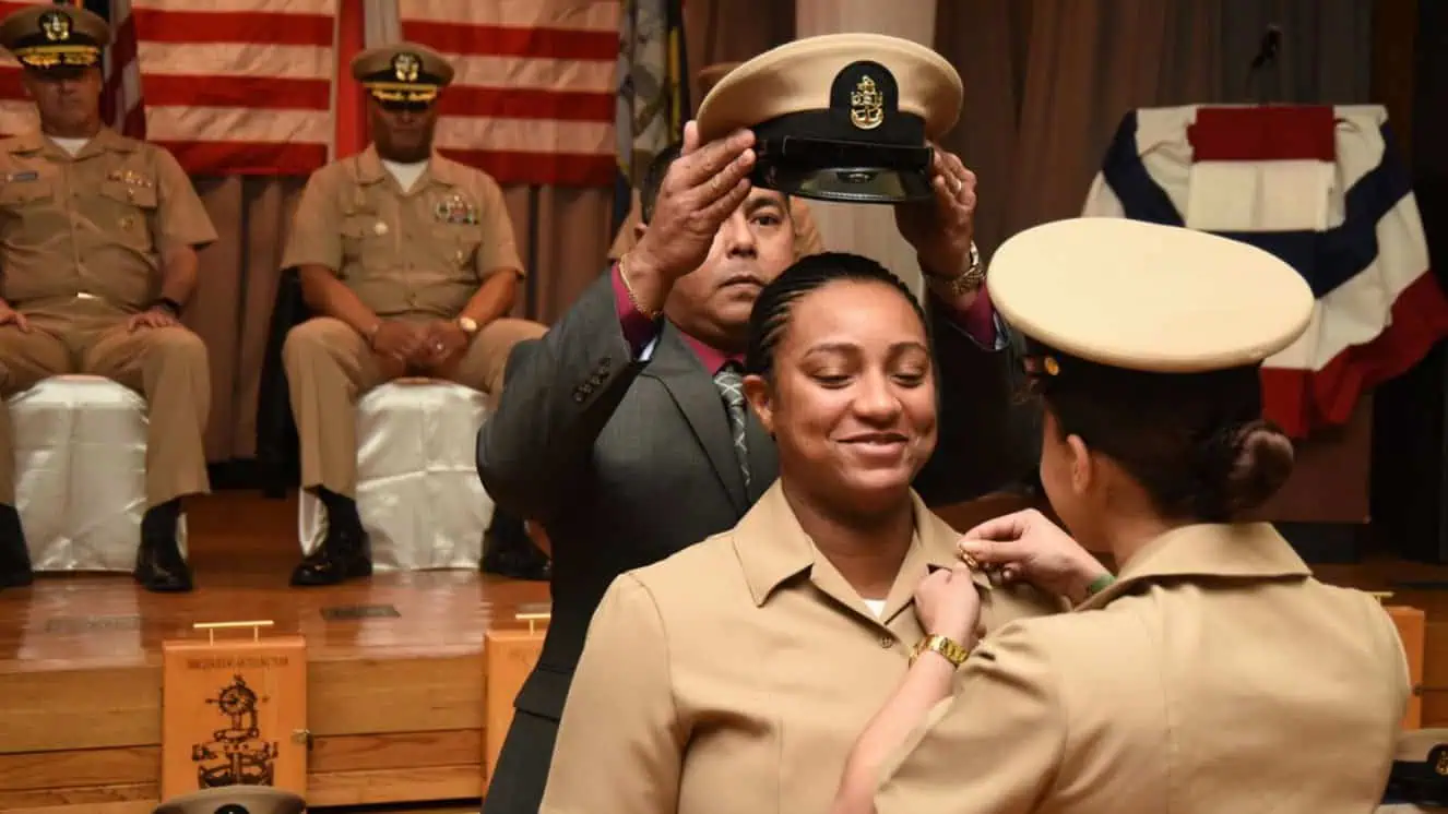 Up or out is of rising concern as Chief Engineman receives her anchors and combination cover during promotion ceremony.