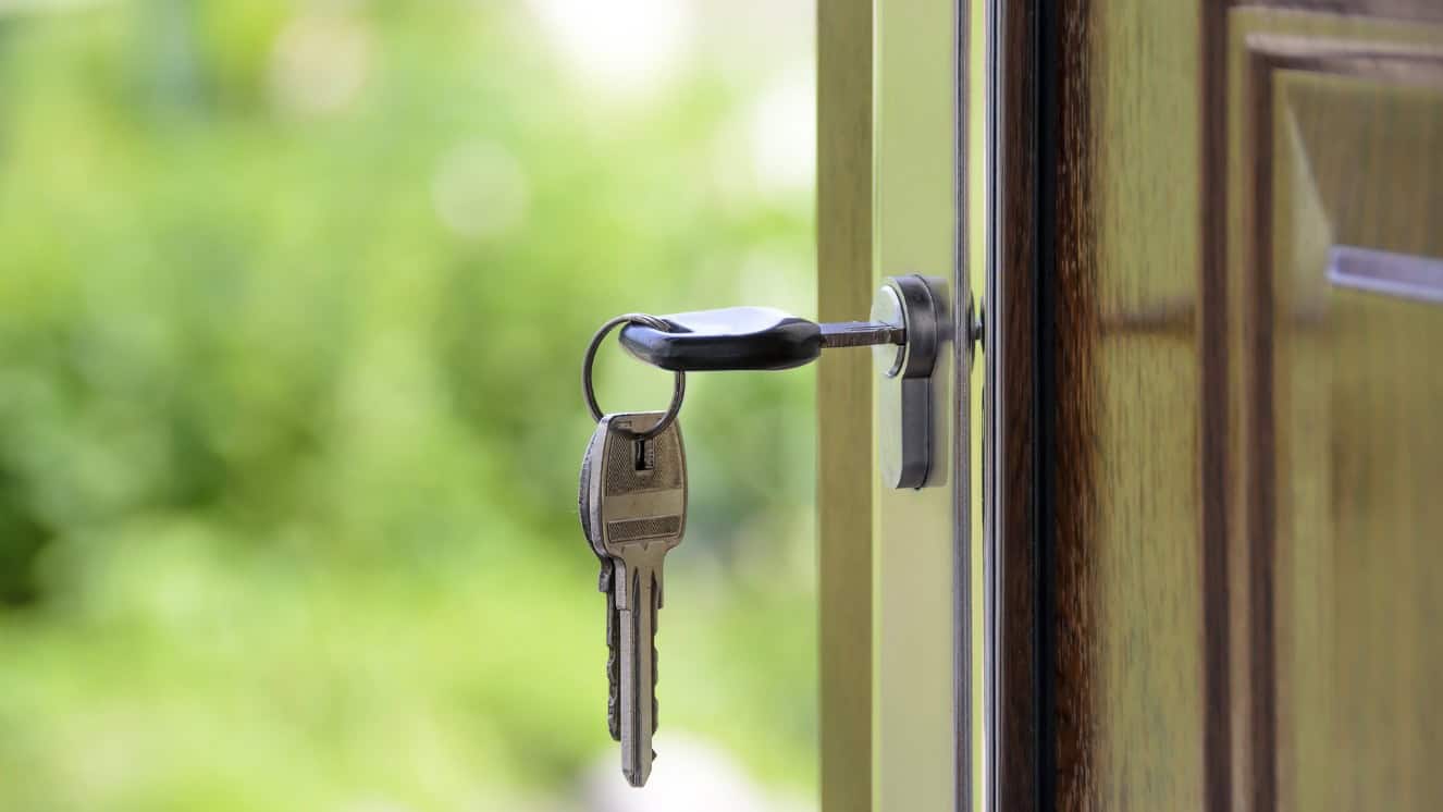 A key in a door of a home after receiving va home loan covid relief.