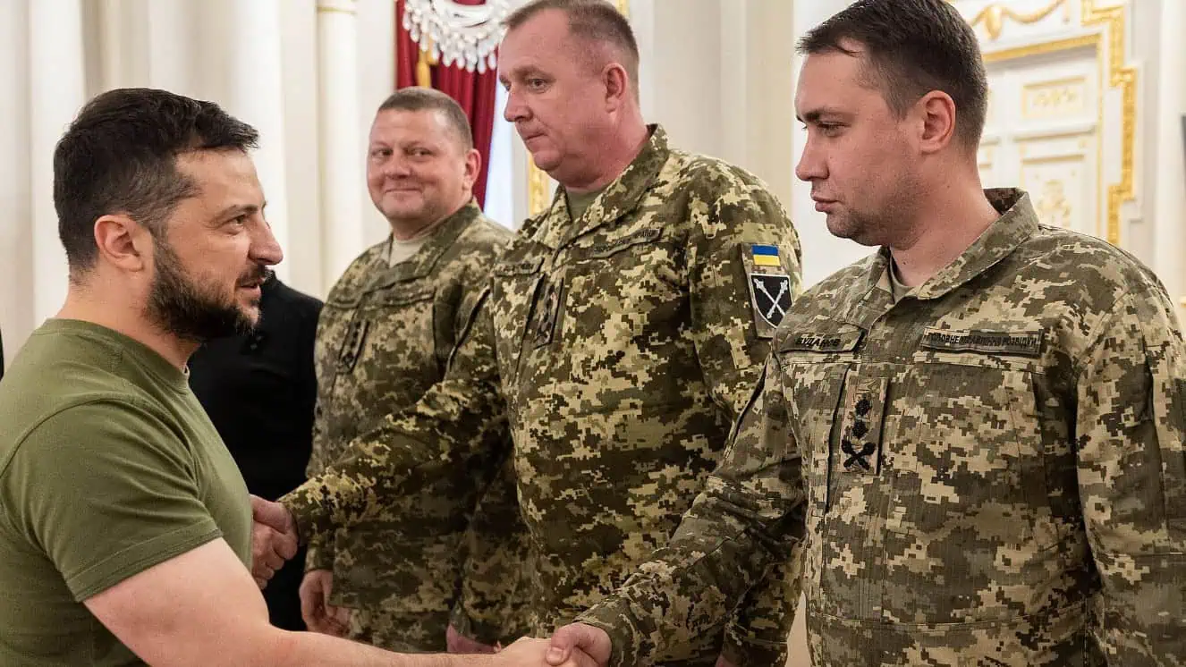 Volodymyr Zelensky shakes hands with Kyrylo Budanov.