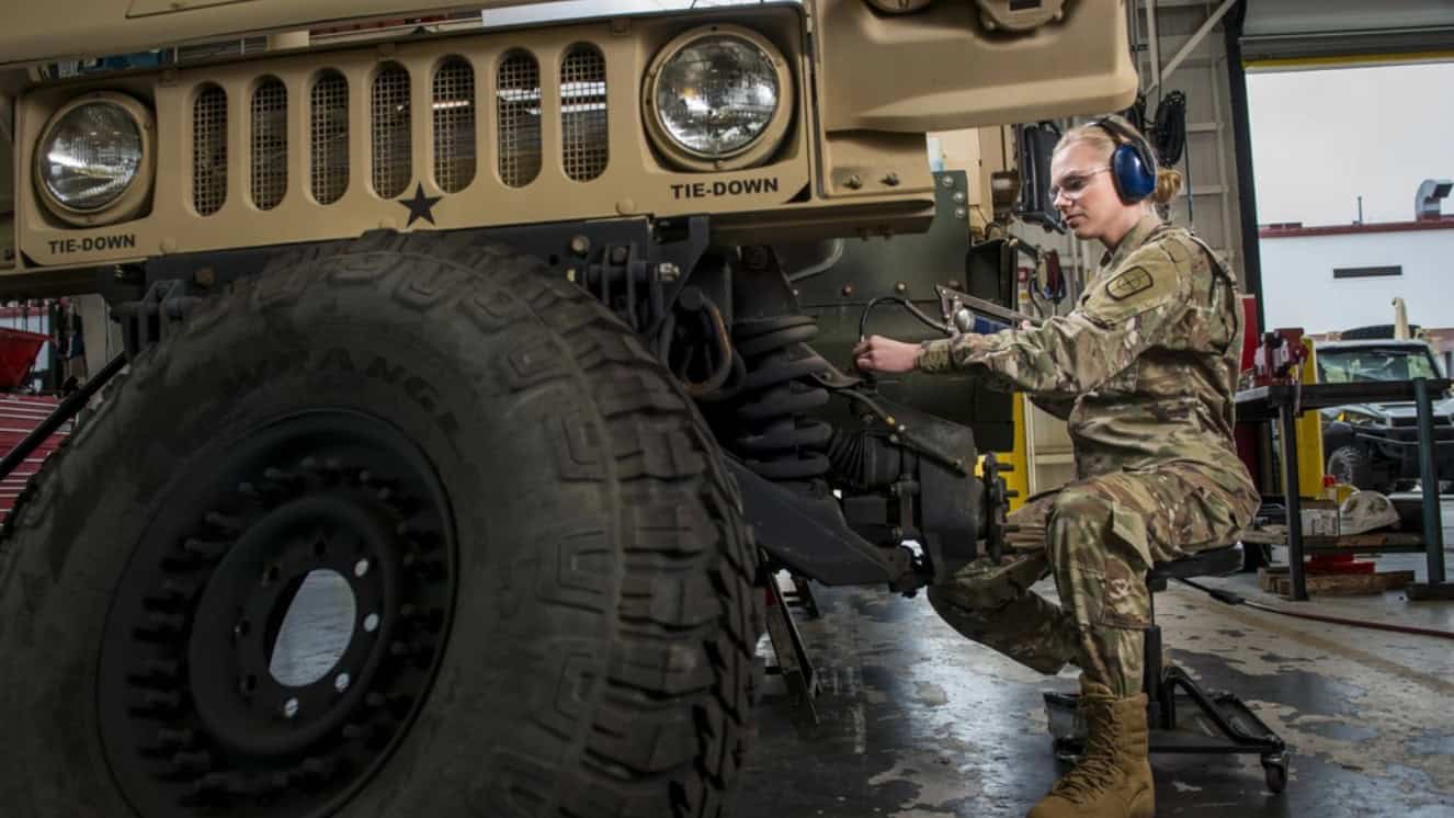 An Army wheeled mechanic working on a vehicle.