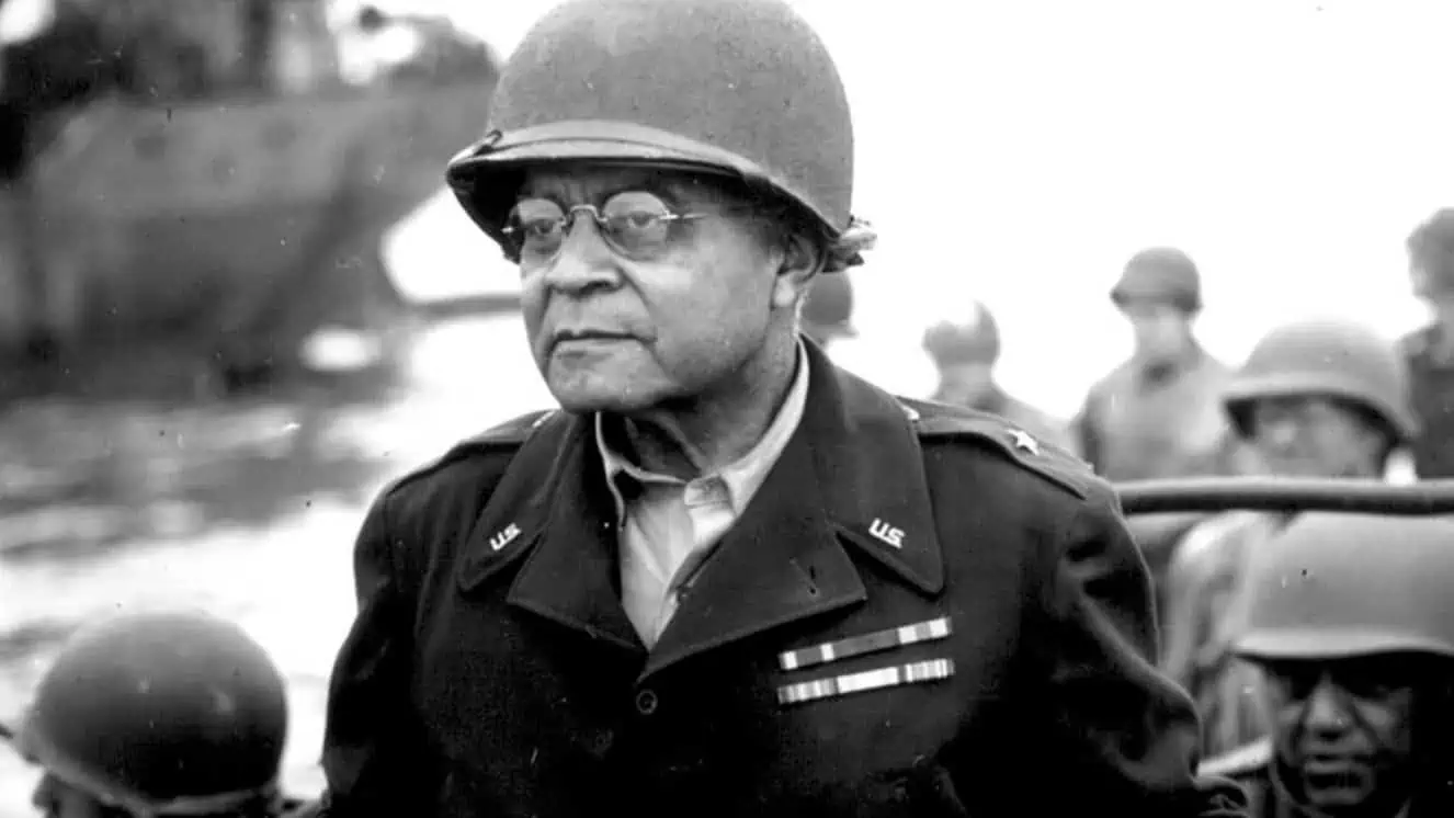 Brig. Gen. Benjamin O. Davis Sr. watches a Signal Corps crew as it erects equipment somewhere in France on Aug. 8, 1944.