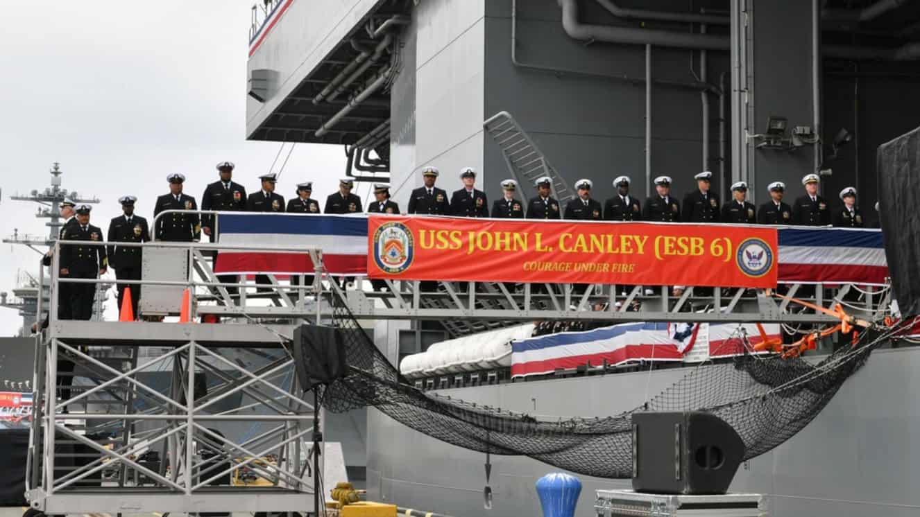 The crew of the expeditionary sea base USS John L. Canley (ESB 6) mans the ship during its commissioning ceremony on Naval Base Coronado Feb. 17, 2024.