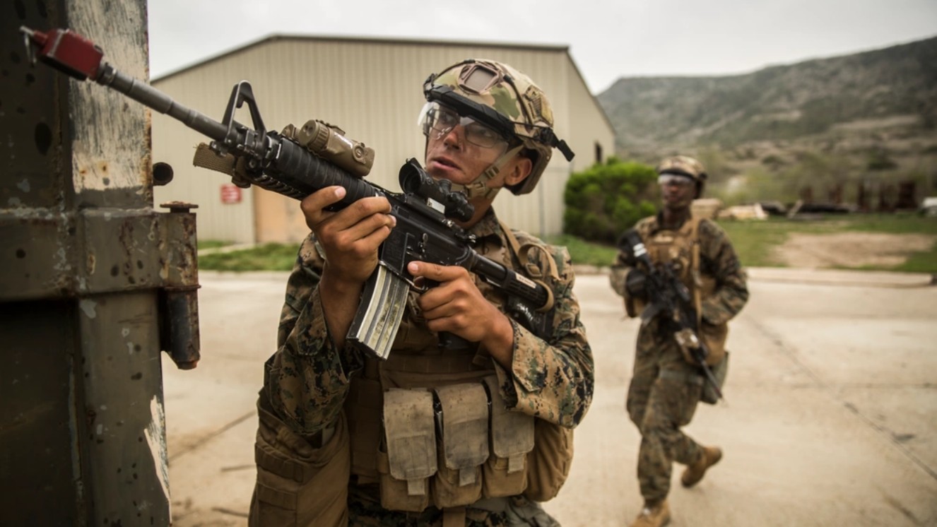 A Marine with Kilo Company, 3rd Battalion, 4th Marine Regiment, 1st Marine Division, provides security while testing an Army helmet during Urban Advanced Naval Technologies Exercise 2018 (ANTX18), March 22, 2018.