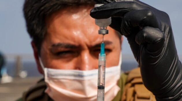 Hospital Corpsman 2nd Class Christopher Maidman prepares ketamine therapy in a syringe during a tactical combat casualty care assessment aboard the amphibious dock landing ship USS Pearl Harbor.