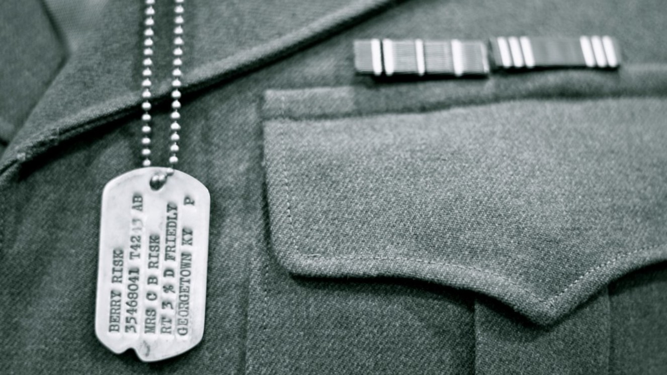 Servicemember wearing a military dog tag.