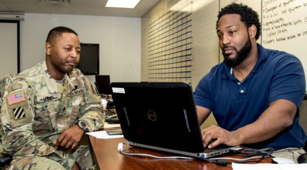 U.S. Army Staff Sgt. Christopher D. Lewis (left), Chemical, Biological, Radiological and Nuclear noncommissioned officer, Headquarters and Headquarters Detachment, 332nd Transportation Battalion, reviews his retired military life insurance policy during a Soldier Readiness Processing event conducted Sept. 25, 2017, in Tampa, Fla. Lewis, a native of Hague, Va., and scores of other Soldiers from the 332nd Trans.