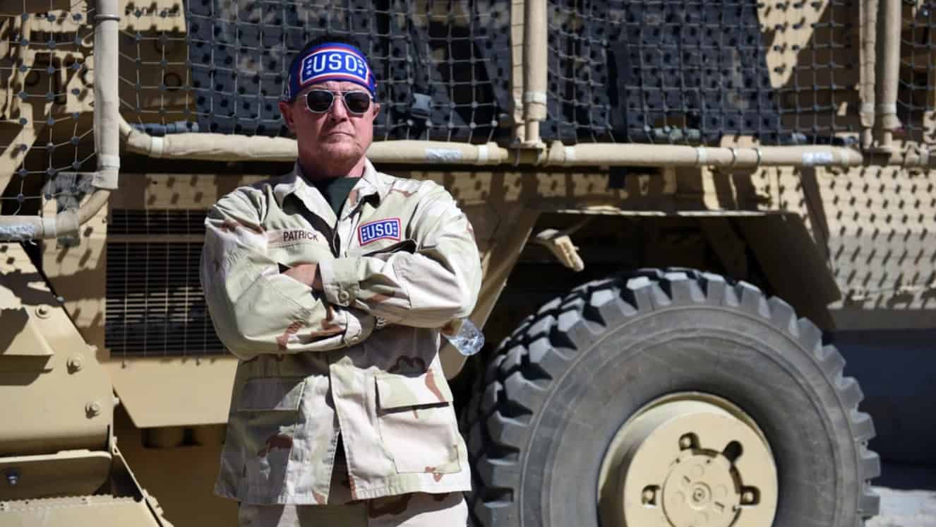 Actor Robert Patrick in "Captain USO" mode beside a Mine-Resistant Ambush Protected vehicle, or MRAP, as Army Gen during USO day. Frank Grass, chief, National Guard Bureau, leads the first-ever National Guard USO Tour, Afghanistan, May 19, 2016.