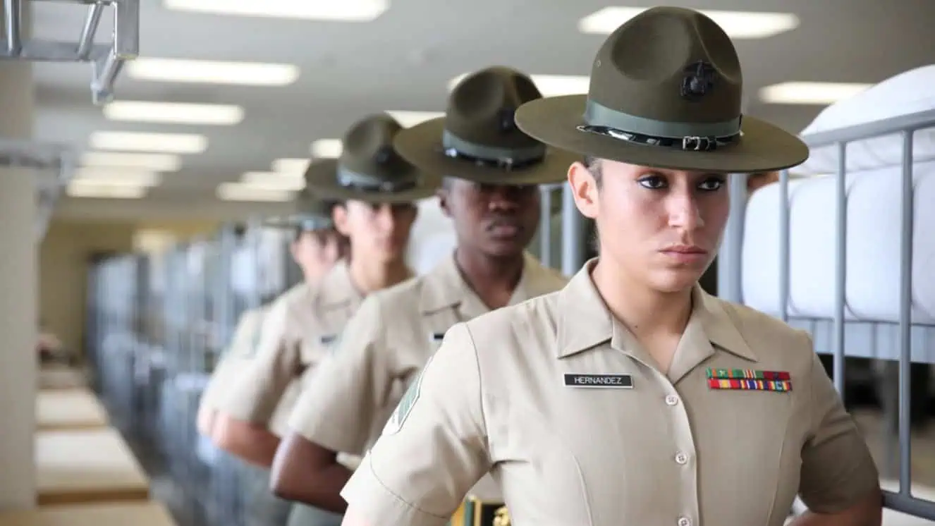 U.S. Marine drill instructors with 4th Recruit Training Battalion, Recruit Training Regiment, Marine Corps Recruit Depot Parris Island stand at parade rest as they wait to give a demonstration of what recruits encounter during pick-up week, the first week of recruit training, during the 70th anniversary of women in the Marines.