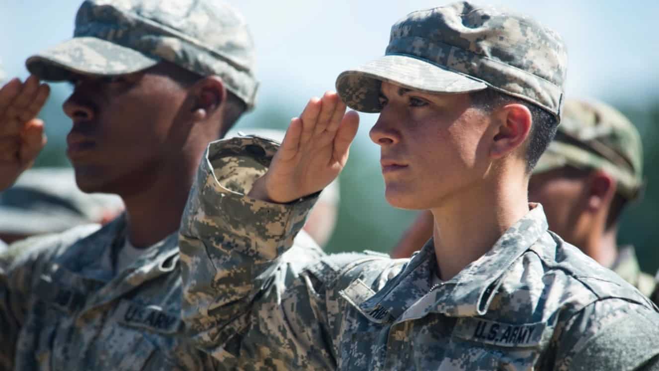 Capt. Kristen Griest and U.S. Army Ranger School Class 08-15 render a salute during their graduation at Fort Benning, Ga., Aug. 21, 2015.
