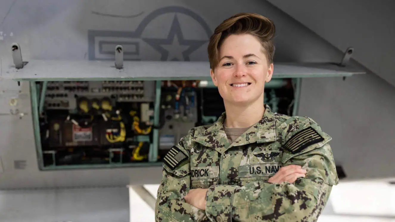 Aviation Electrician's Mate 1st Class Chelsea Kendrick, from Aurora, Colorado, assigned to Naval Air Technical Training Center (NATTC), poses for an environmental portrait in one of NATTC’s hangar bays onboard Pensacola, Florida, March 7, 2023 representing US Navy recruiting.