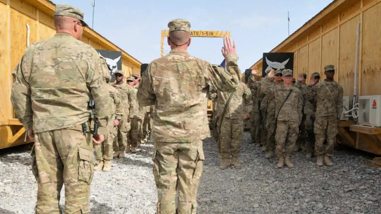 U.S. Army Col. Todd Wood, commander of the 1st Stryker Brigade Combat Team, 25th Infantry Division, leads the re-enlistment ceremony in light of the Army reenlistment bonus.