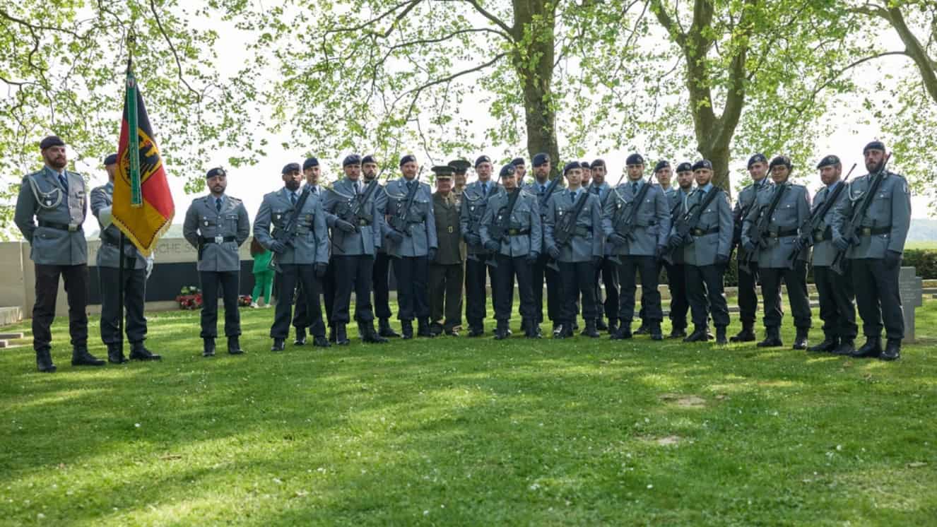 U.S. Marine Corps Maj. Gen. Tracy W. King, U.S. Marine Corps Forces Europe and Africa (MARFOREUR/AF) commander and Sgt. Maj. David M. Elliott, sergeant major of MARFOREUR/AF pose for a group photo with German Army soldiers after a ceremony at the Belleau German military cemetery on May 27, 2023.