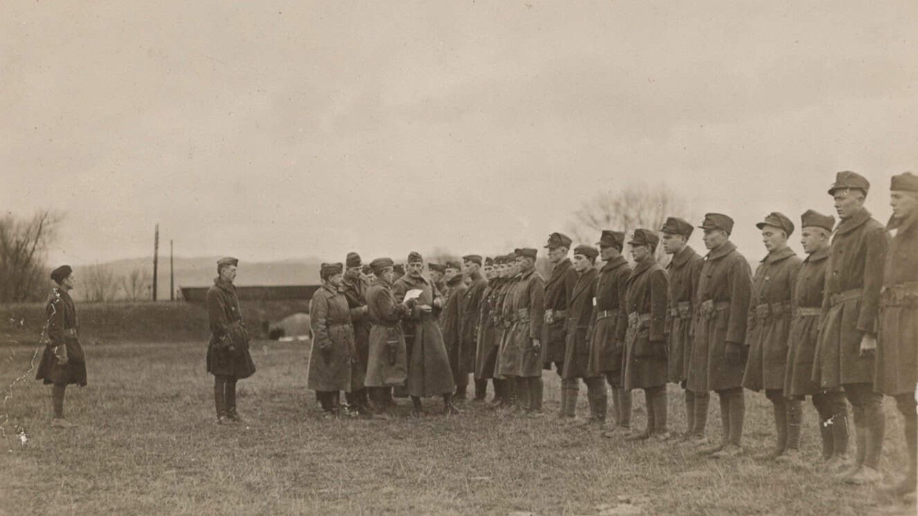 With Army Maj. Gen. Clement Alexander Finley Flagler, commander of the 42nd Division and his staff looking on, Lt. C.L. Michaels reads the order directing the 117th Trench Mortar Battery, 42nd Division, to prepare for redeployment home from Kreuzberg, Germany as Germany declares war on the US following the end of occupation duties January 3, 1919, following World War I.