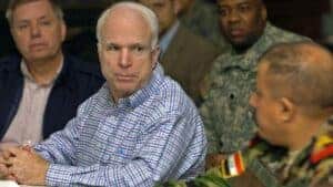 John McCain talking with members of the military.