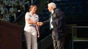 Founder of FedEx shaking the hand of a Soldier.