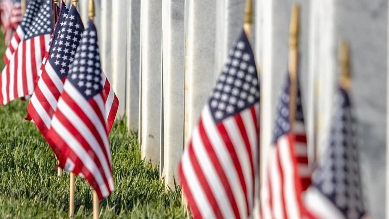 Remembering those who served with flags on graves during memorial day 2024.