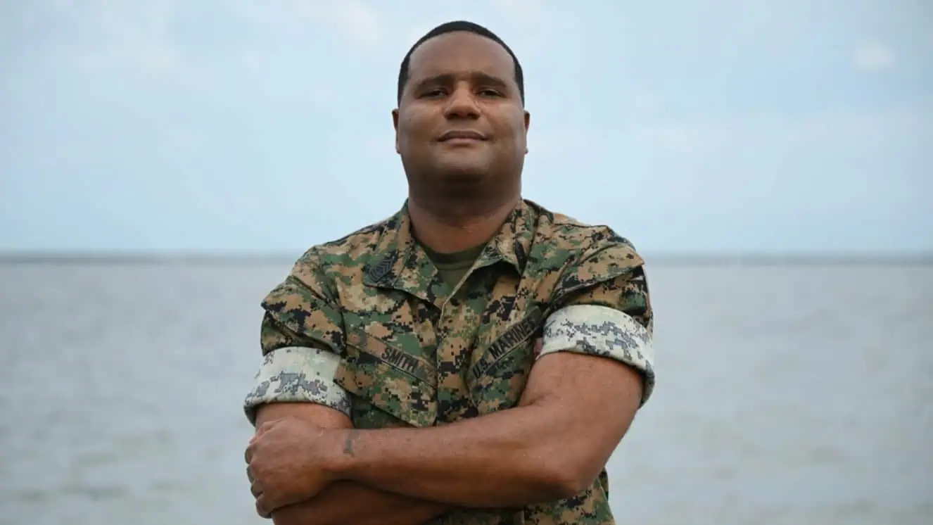 Solider standing on beach during military appreciation month.