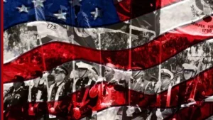 The graphics consists of a dark blue side bar on the left with text and the Camp Pendleton Base icon with 6 stars in line dividing text. On the right side is a photo of military members in a parade holding each branch of services flag in black and white in the background. Over top of the photo is an image of the U.S. Flag superimposed with an artistic filter where blue and red from the flag appear transparent for military appreciation month ideas.