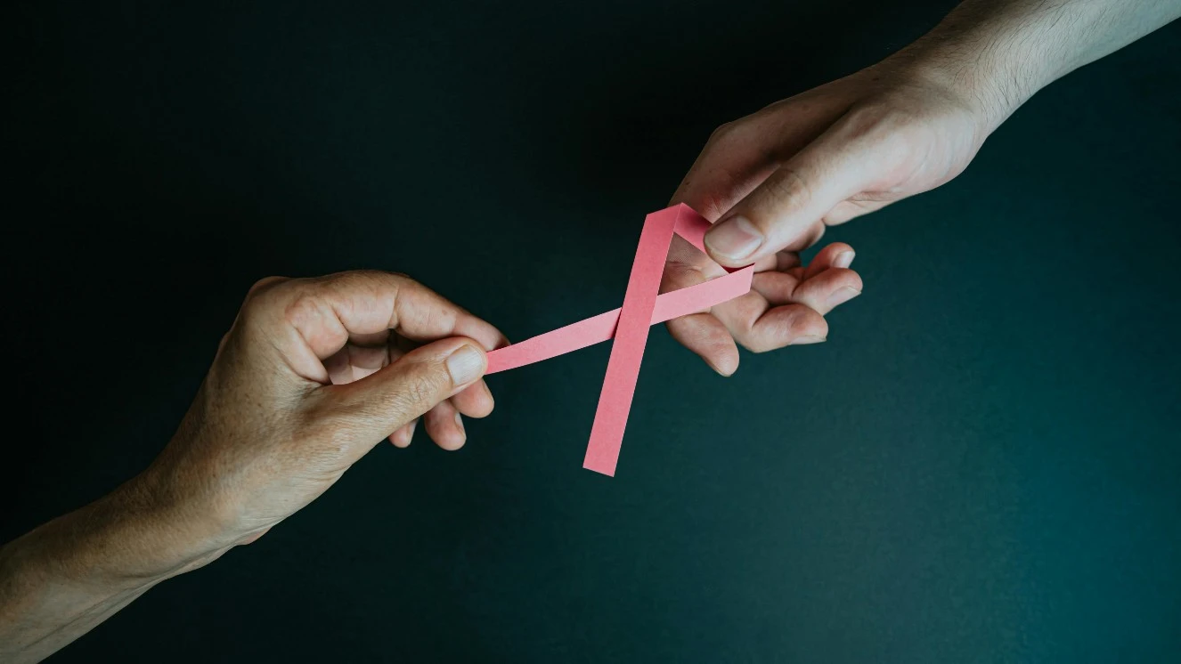 Male breast cancer awareness graphic holding the cancer sign.