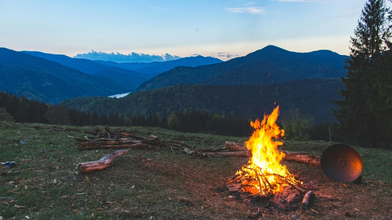 Outdoor survival skills being used at a campground with a fire.