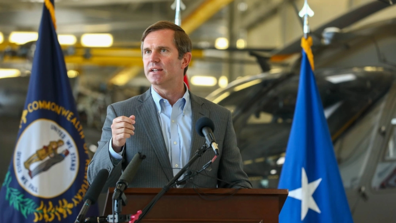 Andy Beshear talking at a press conference at the Army Aviation Support Facility on Boone National Guard Center in Frankfort.