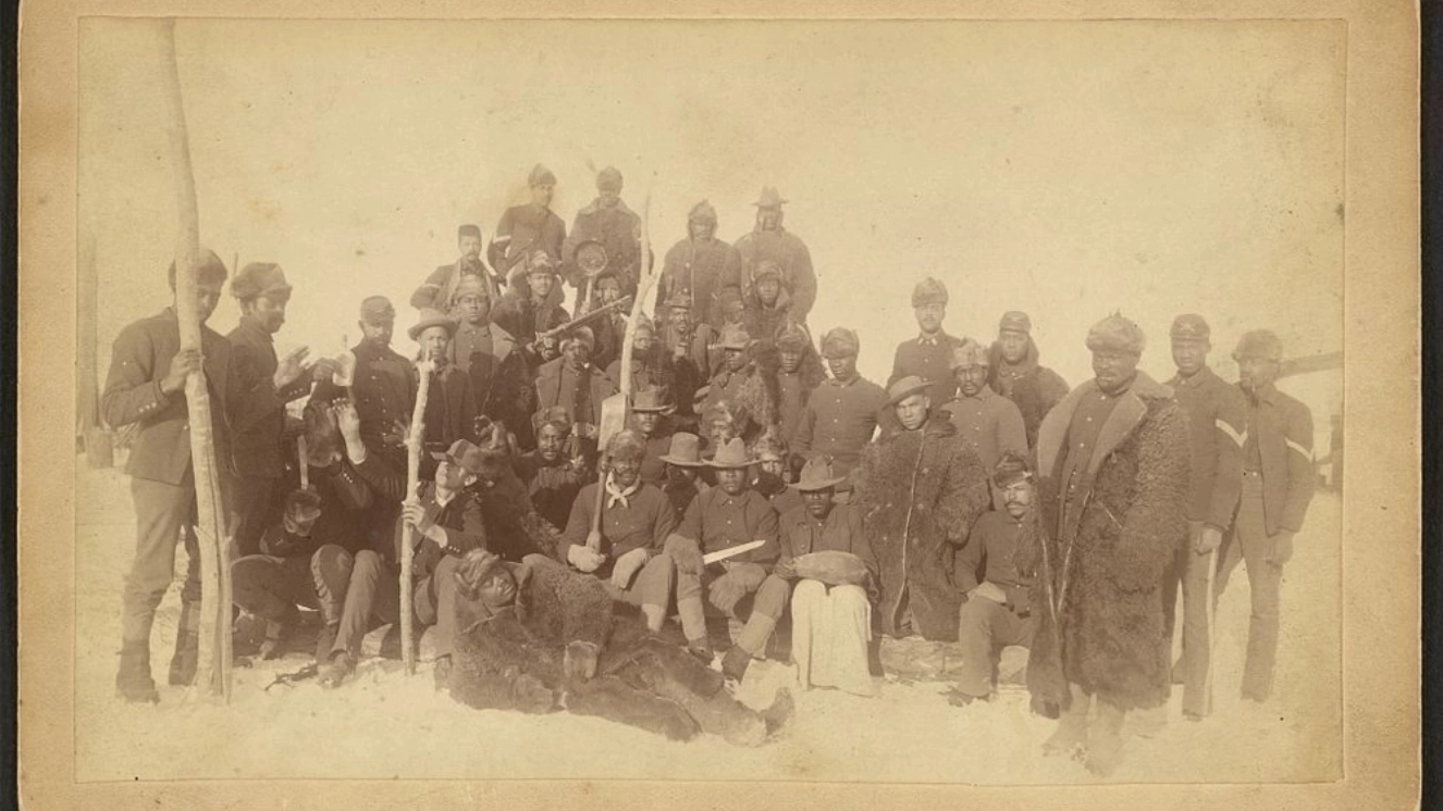 Buffalo soldiers of the 25th Infantry, some wearing buffalo robes, Ft. Keogh, Montana to commemorate Buffalo Soldiers Day.