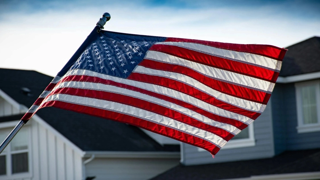 Waving an American Flag and wishing a "Happy Birthday America" on the 4th.