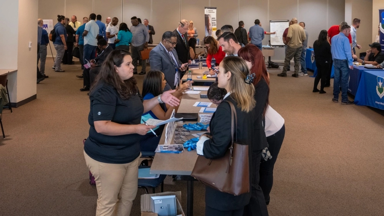 Job seekers move from table to table at a Joint Base San Antonio Veteran job fair hiring event at St. Philips college, San Antonio, Texas, April 12, 2023